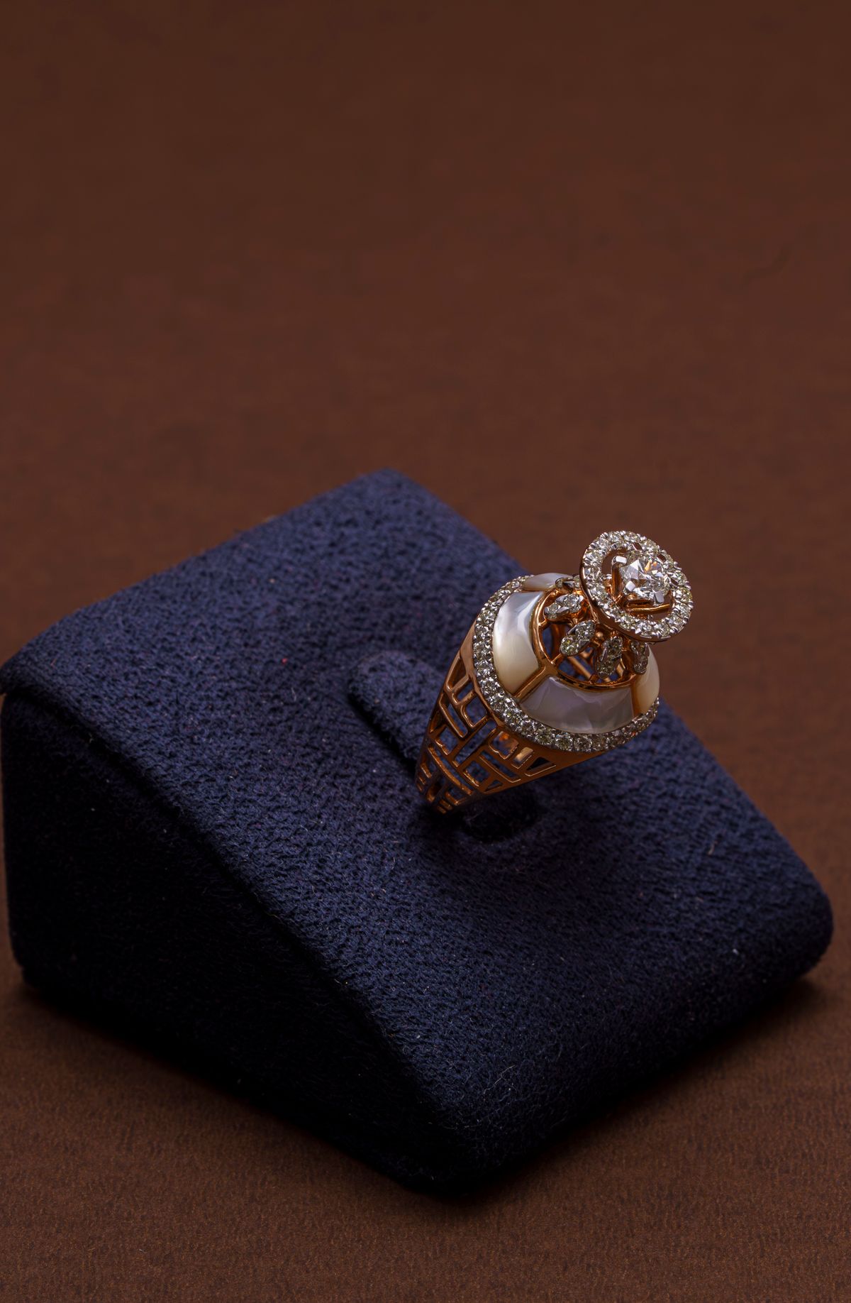 turntable 360 video frame of a rose gold ring on a dark reflective surface