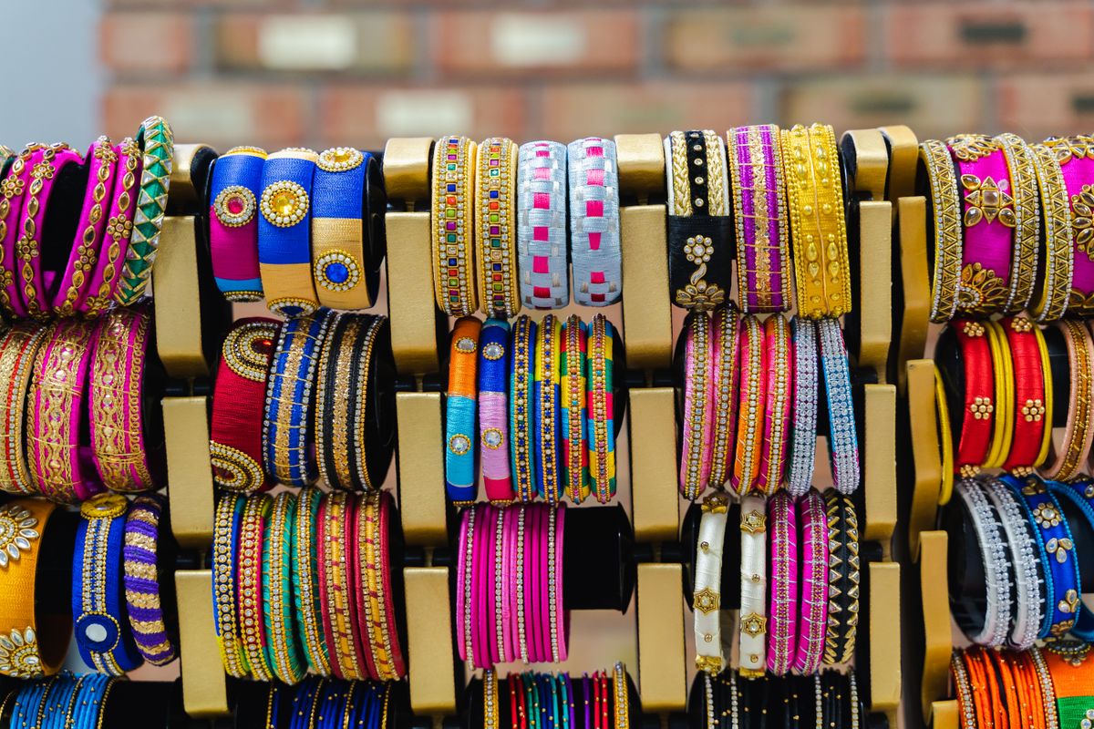 display rack of colourful silk-thread bangles stacked by colour