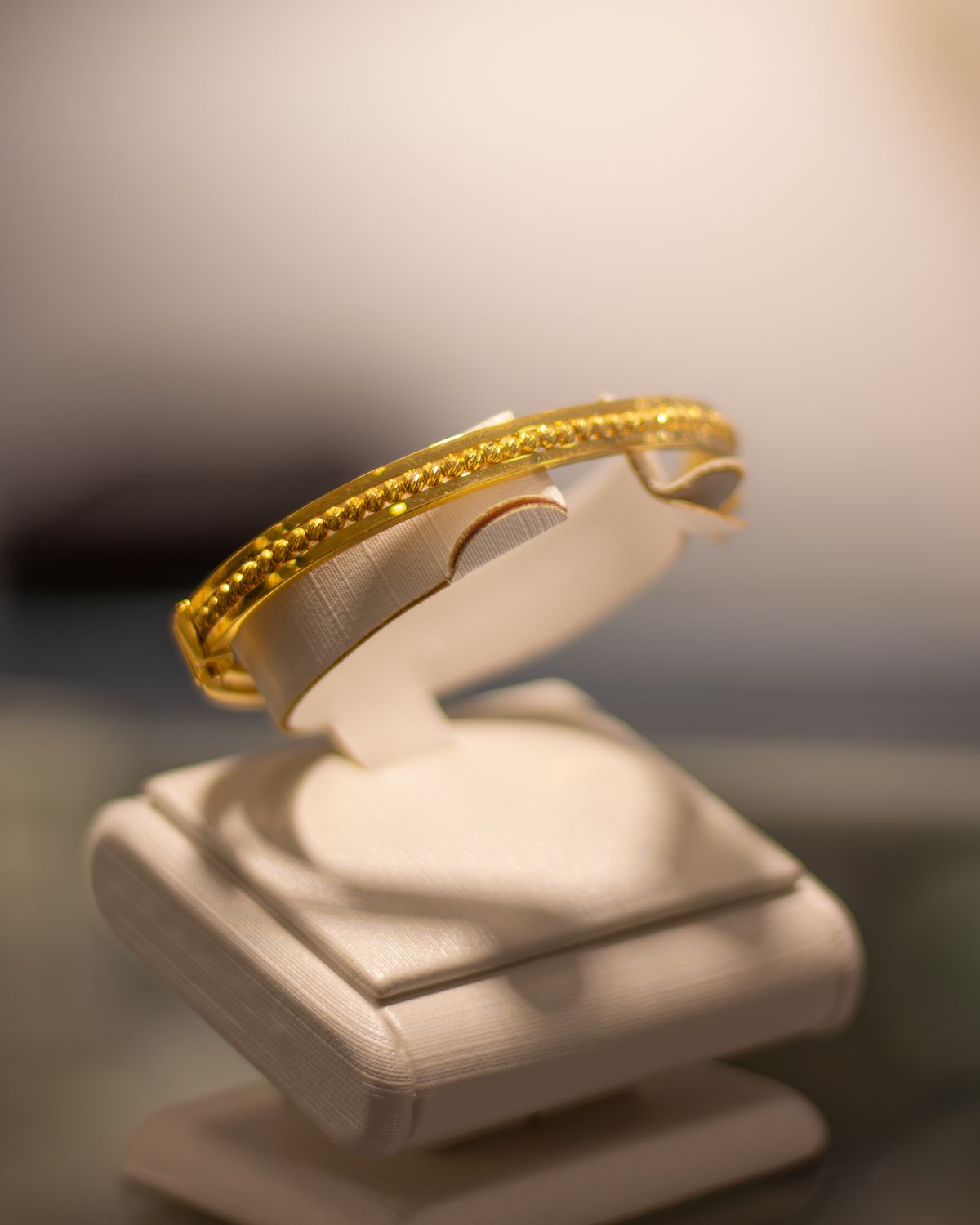 3d render of a yellow gold bangle bracelet with channel set diamonds