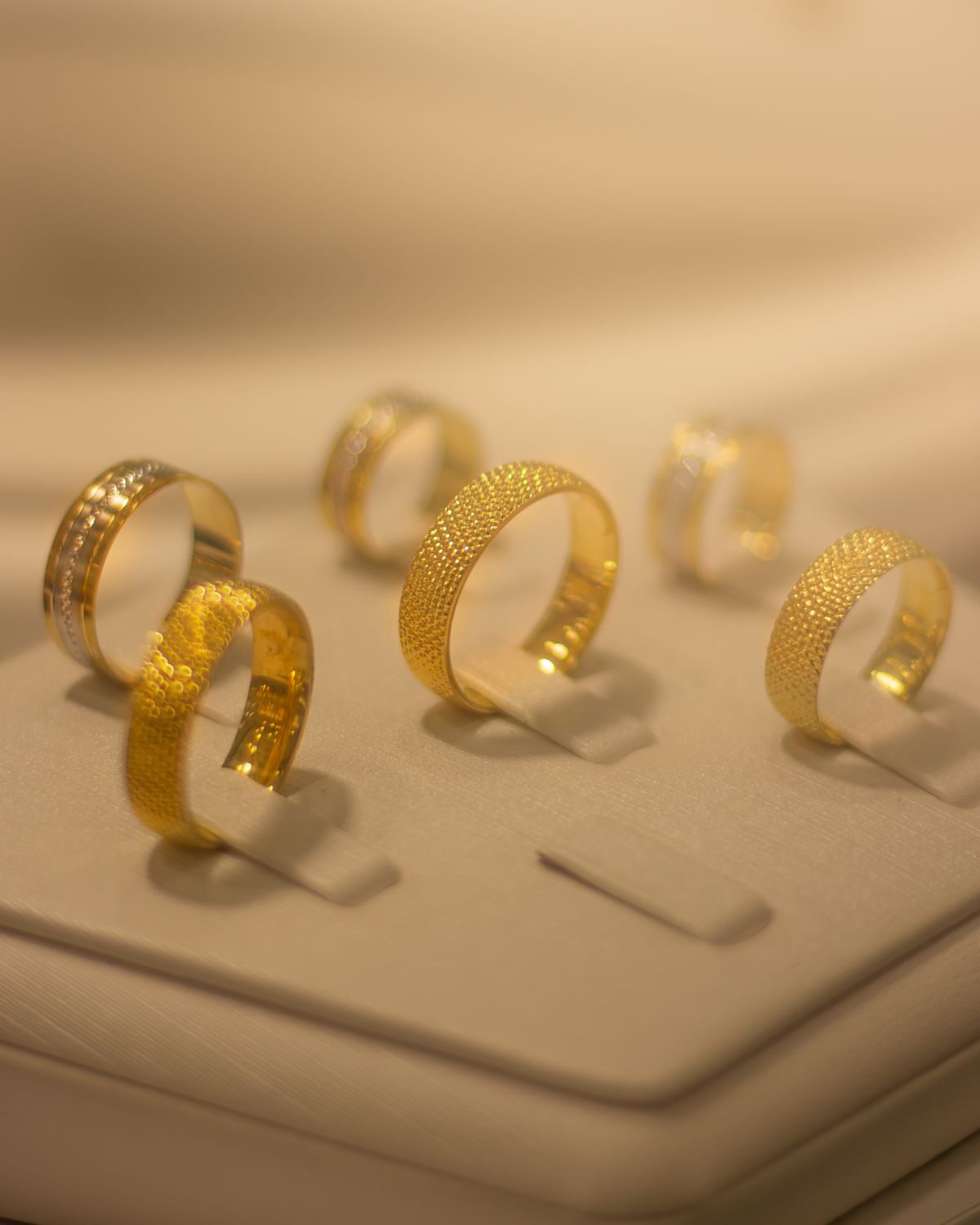 gold rings staged on a display stand
