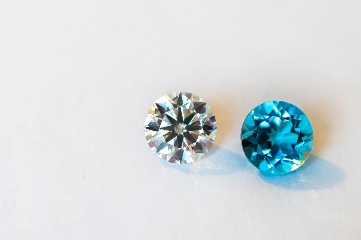 two loose cut gemstones rendered on white